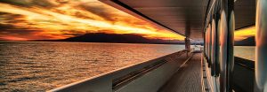 side view of superyacht with sunset reflecting on chrome